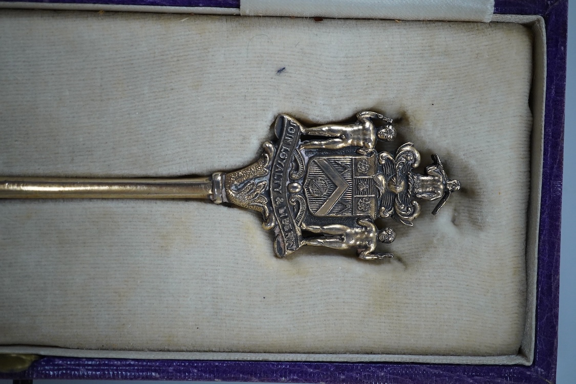 A cased silver gilt and polychrome enamelled spoon, the terminal modelled as the crest of the Worshipful Company of Joiners and Ceilers, to commemorate the Coronation of George V in 1911, Levi & Salaman, London, 1910, 17